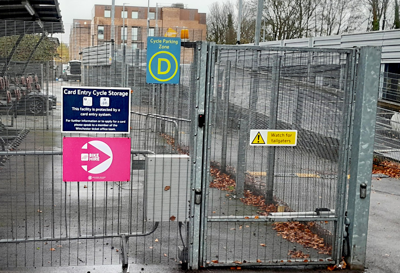 Photo of the entry gate to a "secure" cycle parking compound at Winchester station.